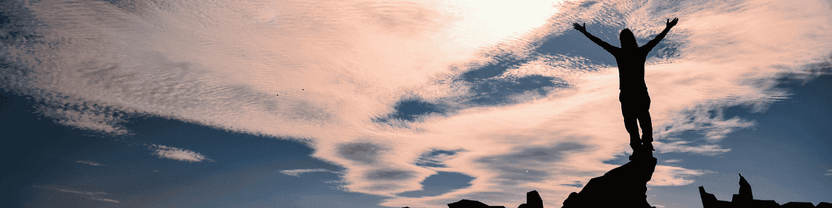 Person receiving Thai massage outdoors with sunset sky in Glasgow.