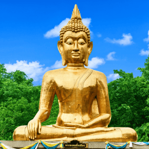 Golden Buddha statue in lush green setting, symbolising Thai healing traditions.